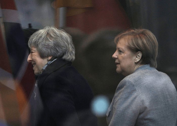 Past Their Sell-By Dates, Merkel and May Cling on to Power with Plot and Process
